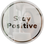 Text that says "stay positive" with photo of woman smiling behind it